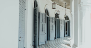 A long, sunlit colonnade with a row of open doors and archways, symbolising the new opportunities and entry points AI opens up