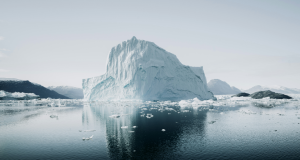 An iceberg floating in dark water with most of its mass hidden below the surface, symbolising hidden cybersecurity debt
